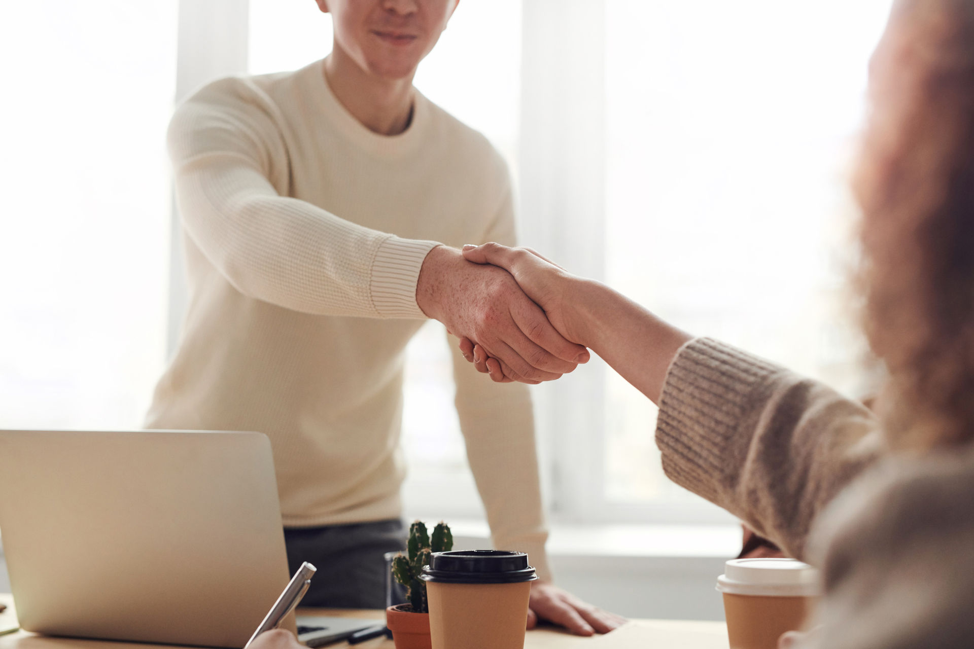 Professional handshake in a modern office